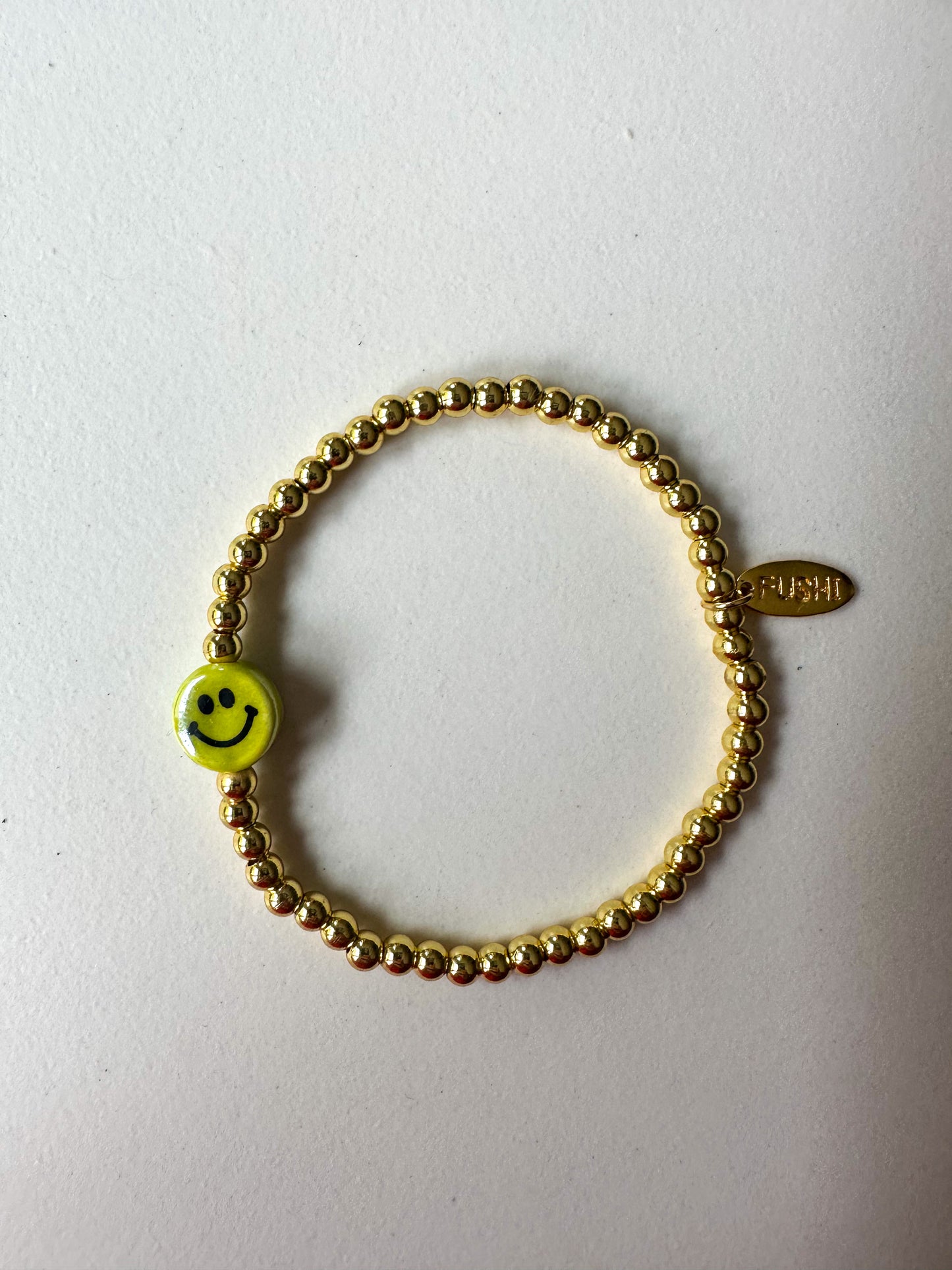 Armband goud met keramiek gele smiley - RUBY Conceptstore